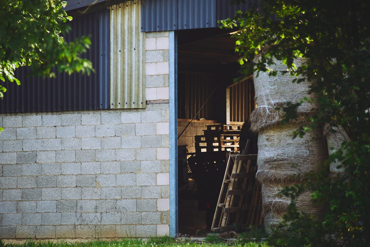 a hay store with hay bales and palettes