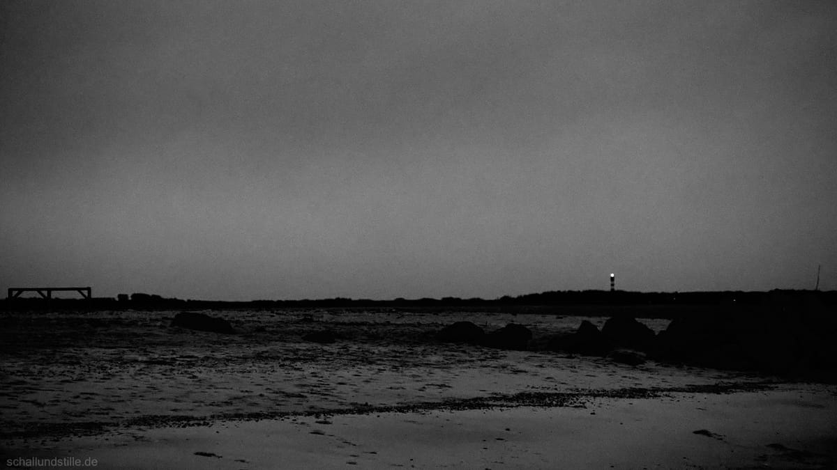 a deserted beach in black and white