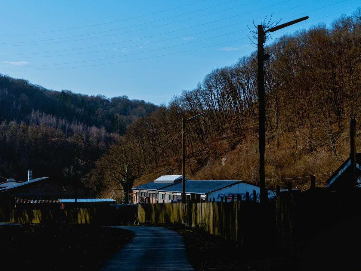 An industry building in a valley between two hills