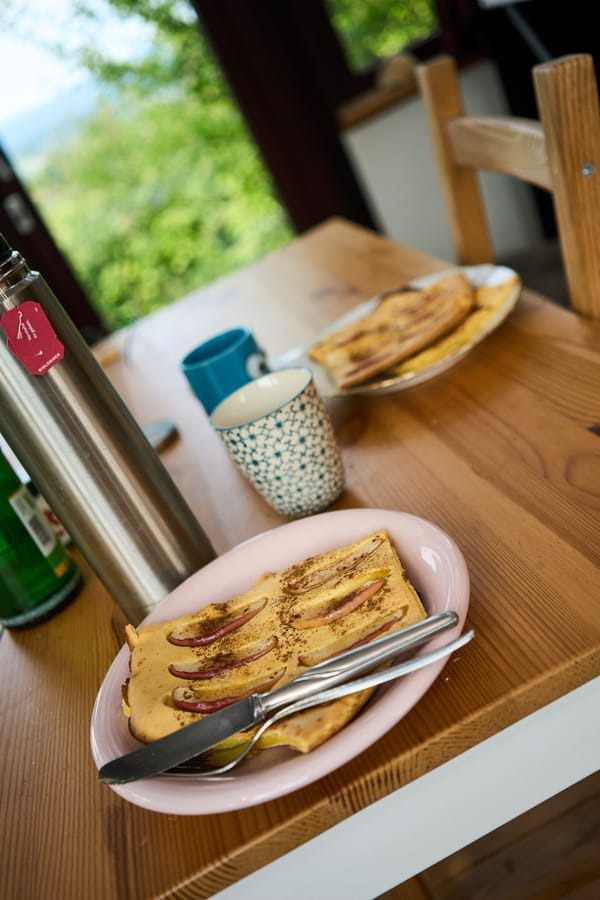 a breakfast table with apple and cinnamon pancakes
